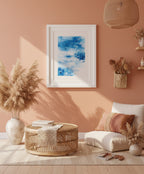 Abstract blue painting matted in a white frame against a light peach background.