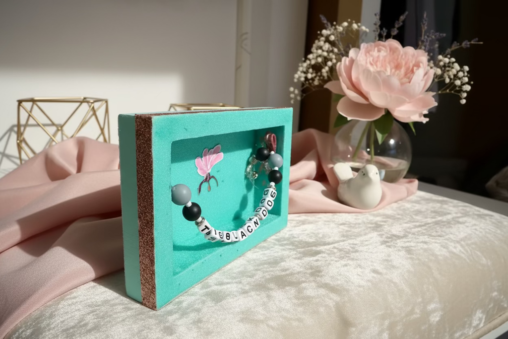 Small turquoise book with decorative elements on a wooden surface