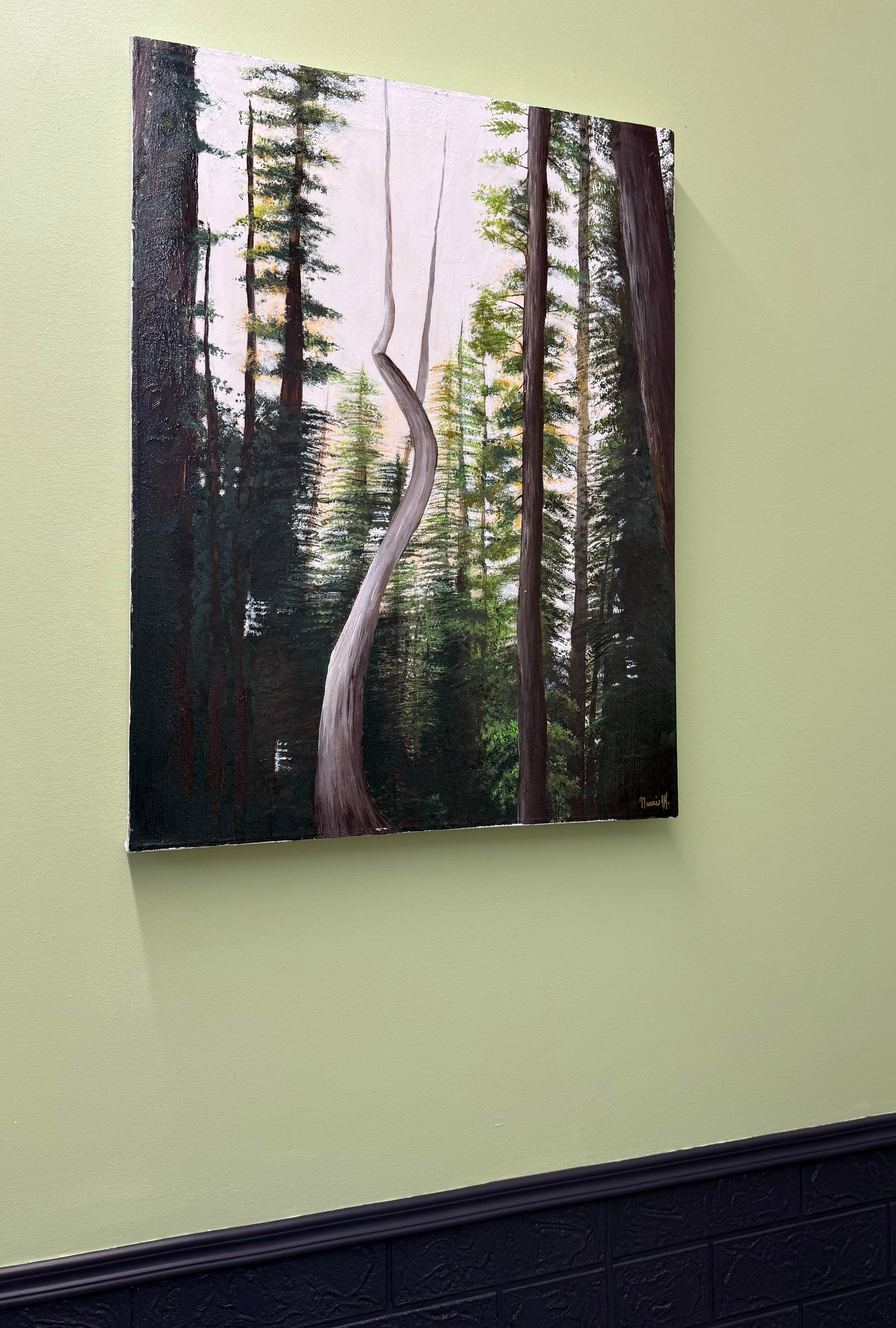 Forest scene painting on a light green wall