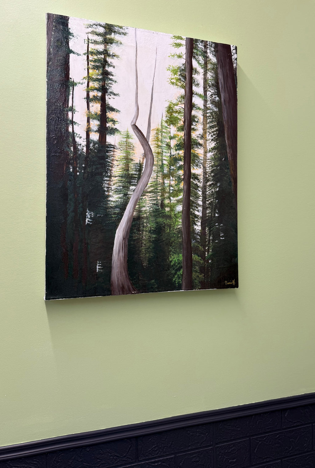 Forest scene painting on a light green wall