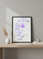 Framed artwork of purple flowers on a wooden shelf with decorative items.