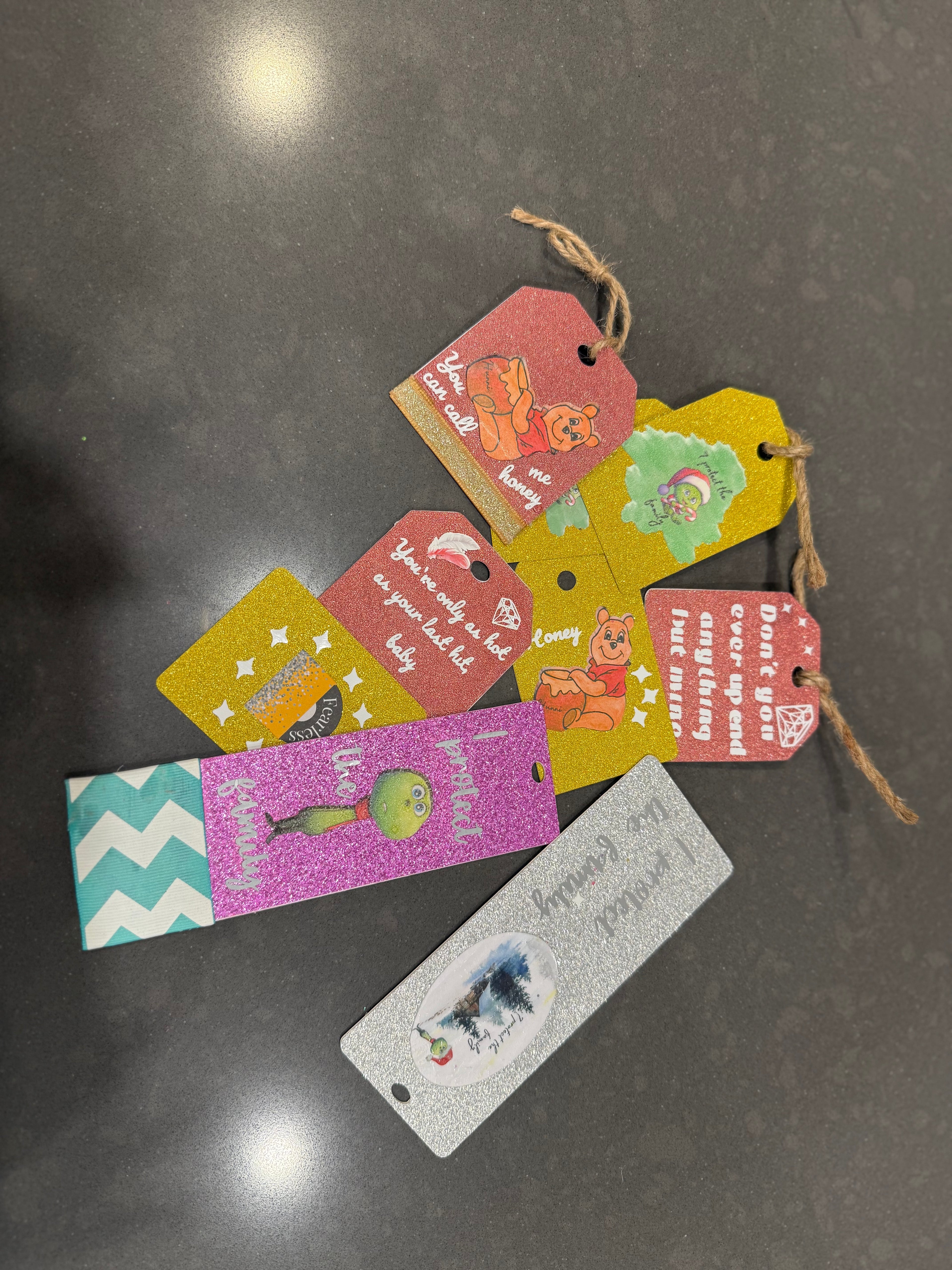 Colorful gift tags and bookmarks on a dark surface