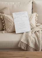 Energy and emotional tracking worksheet with space to reflect on shifts, influences, and grounding practices placed on a white couch with a boho fringe lumbar pillow beige and a tweed beige blanket. 