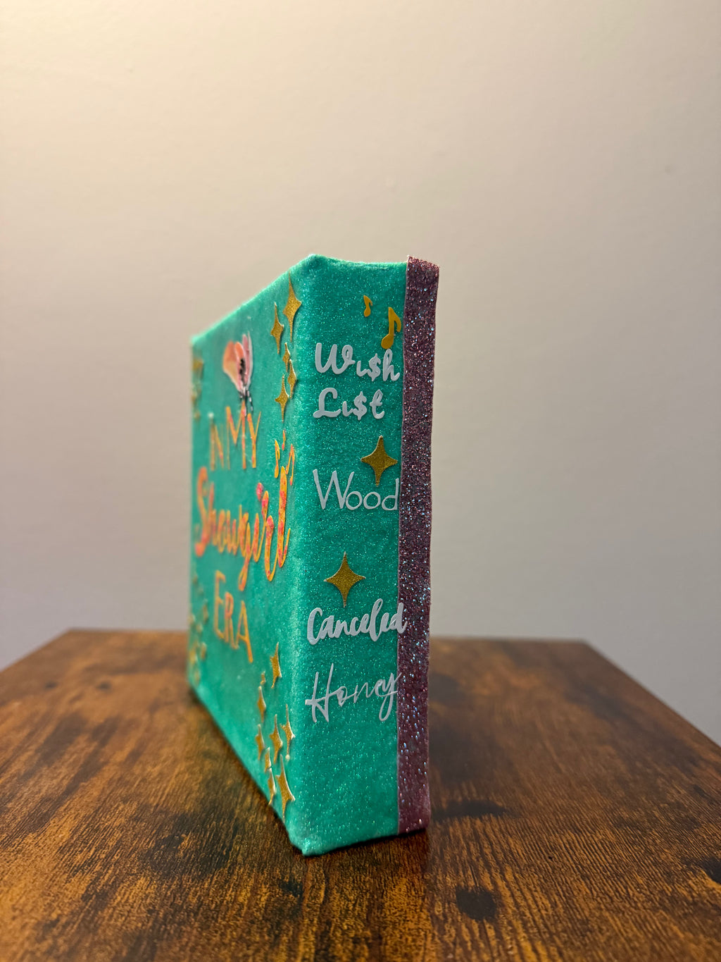 Decorative book with text and star designs on a wooden surface