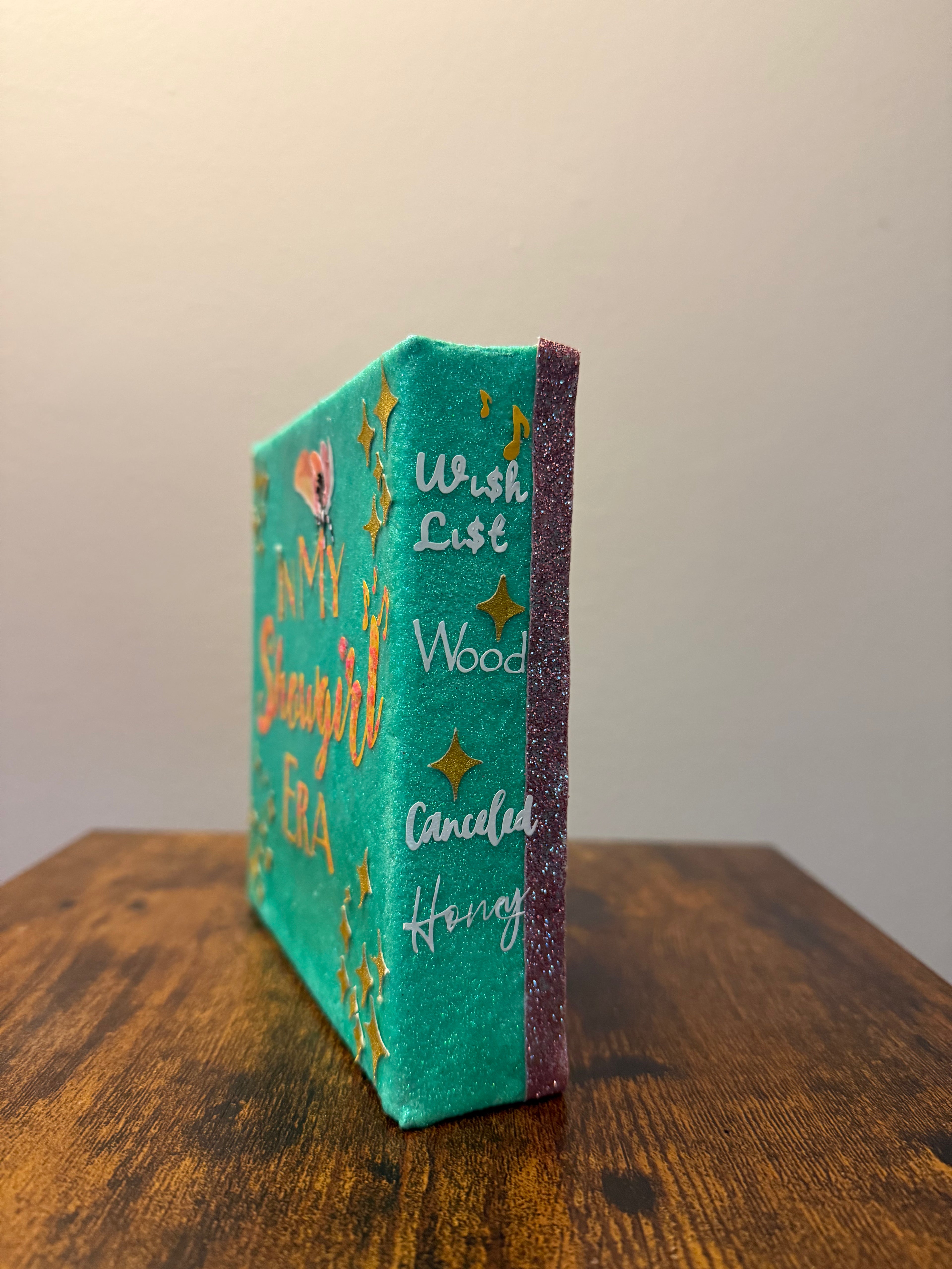 Decorative book with text and star designs on a wooden surface